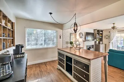 a kitchen with a large island in a living room at 1 Mi to Main Street Sutter Creek Poolside Oasis! in Sutter Creek