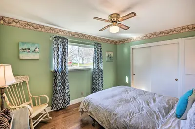 a bedroom with green walls and a ceiling fan at 1 Mi to Main Street Sutter Creek Poolside Oasis! in Sutter Creek