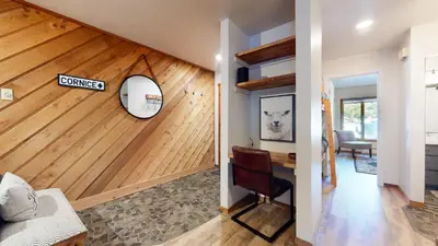a living room with a wooden wall at Snowcreek I #11 condo in Mammoth Lakes