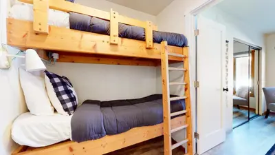 a bedroom with two bunk beds in a room at Snowcreek I #11 condo in Mammoth Lakes