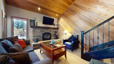 a living room with a couch and a fireplace at Snowcreek I #28 condo in Mammoth Lakes