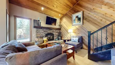 a living room with a couch and a fireplace at Snowcreek I #28 condo in Mammoth Lakes