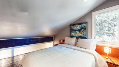 a bedroom with a large white bed and a window at Snowcreek I #28 condo in Mammoth Lakes