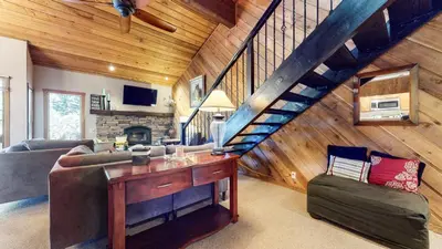 a living room with a couch and a staircase at Snowcreek I #28 condo in Mammoth Lakes