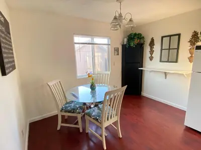 a dining room with a glass table and two chairs at WHOLE Family - Wholestyl in Sacramento