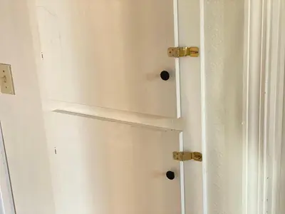 a white door with two black knobs on it at WHOLE Family - Wholestyl in Sacramento