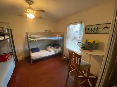 a bedroom with bunk beds and a desk and a chair at WHOLE Family - Wholestyl in Sacramento