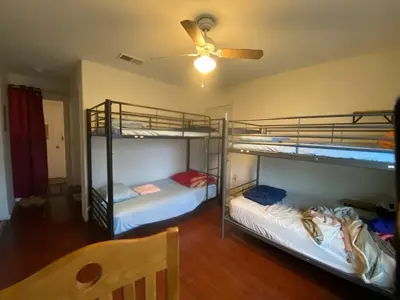 two bunk beds in a room with a ceiling fan at WHOLE Family - Wholestyl in Sacramento