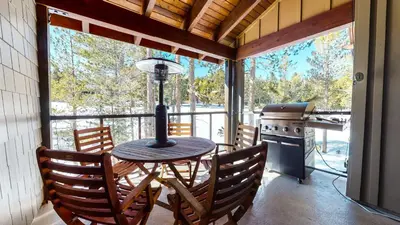 a porch with a table and chairs and a stove at Woodwinds #1271 townhouse in Mammoth Lakes