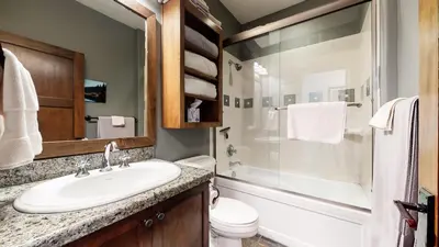 a bathroom with a sink and a toilet and a shower at Woodwinds #1271 townhouse in Mammoth Lakes