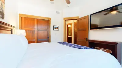 a bedroom with a bed and a flat screen tv at Woodwinds #1271 townhouse in Mammoth Lakes
