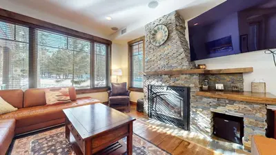 a living room with a couch and a fireplace at Woodwinds #1271 townhouse in Mammoth Lakes