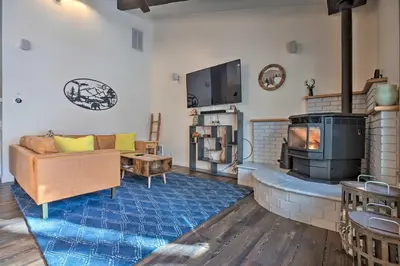 a living room with a couch and a fireplace at Epic Mammoth Lakes Getaway with Shared Pool, Hot Tub in Mammoth Lakes