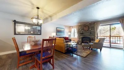 a living room with a table and a dining room at Mammoth Creek #9 condo in Mammoth Lakes