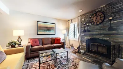 a living room with a couch and a fireplace at Mammoth Creek #9 condo in Mammoth Lakes