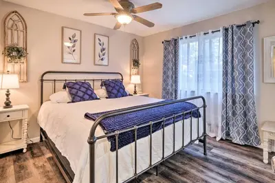 a bedroom with a bed and a ceiling fan at Lakeside Groveland Home with Hot Tub, Near Yosemite in Groveland