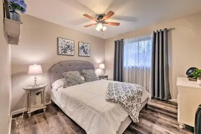 a bedroom with a bed and a ceiling fan at Lakeside Groveland Home with Hot Tub, Near Yosemite in Groveland