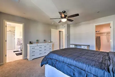 a bedroom with a bed and a ceiling fan at 4 Mi to City Center Family-Friendly Retreat! in Merced