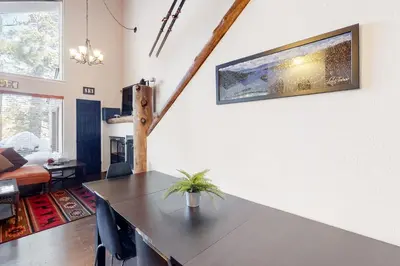 a living room with a table with a plant on a wall at Back Country Basecamp in Stateline