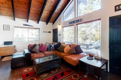 a living room with a couch and a table at Back Country Basecamp in Stateline