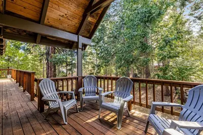 a deck with four chairs and a table on it at Majestic Mountain in Dorrington