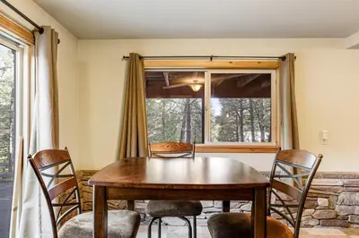 a dining room with a table and chairs and a window at Majestic Mountain in Dorrington