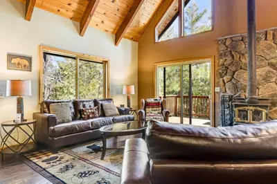 a living room with leather furniture and a stone wall at Majestic Mountain in Dorrington