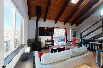 a living room with a couch and a piano at Overlook Nook in Stateline