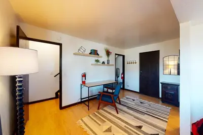 a living room with a table and a chair at Overlook Nook in Stateline