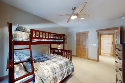 a bedroom with two bunk beds and a ceiling fan at Snow Porch in Truckee