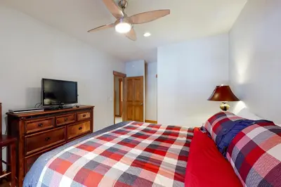 a bedroom with a bed and a flat screen tv at Snow Porch in Truckee