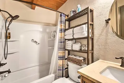 a bathroom with a shower and a toilet and a sink at Dog-Friendly Kings Beach Log Cabin with Hot Tub! in Kings Beach