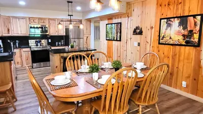 a dining room with a wooden table and chairs at Sequoia Trails, mountains, fun & relax in Ponderosa