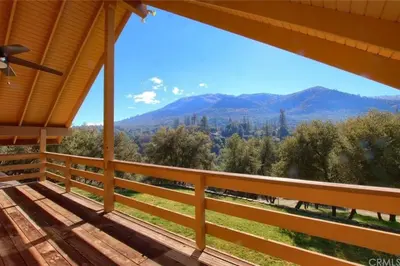 a porch with a view of the mountains at Yosemite Riverside Retreat with small beach access and air conditioning in Oakhurst
