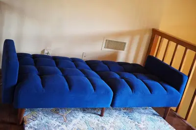 a blue couch sitting in a living room at Yosemite Riverside Retreat with small beach access and air conditioning in Oakhurst