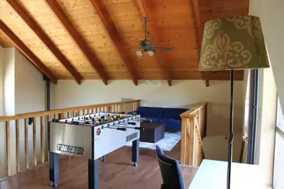 a ping pong table in a room with a ceiling at Yosemite Riverside Retreat with small beach access and air conditioning in Oakhurst