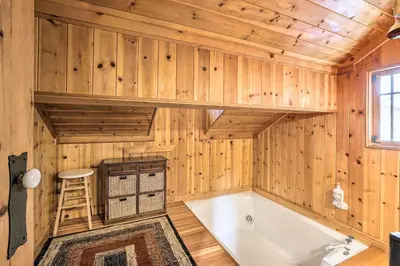 a bathroom with a tub and a wooden wall at Less Than 1 Mi to Heavenly Lifts Tahoe Area Townhome! in Stateline