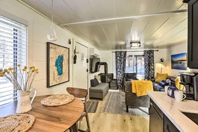 a kitchen and living room with a table in a room at Walk to Lake Tahoe Cozy Zephyr Cove Cabin! in Zephyr Cove