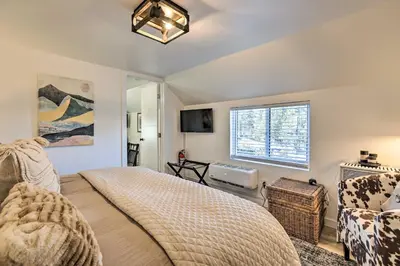 a bedroom with a bed and a tv and a window at Walk to Lake Tahoe Cozy Zephyr Cove Cabin! in Zephyr Cove