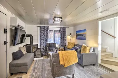 a living room with a couch and chairs and a television at Walk to Lake Tahoe Cozy Zephyr Cove Cabin! in Zephyr Cove