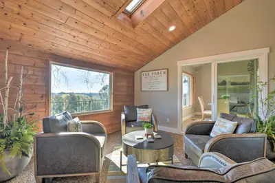 a living room with couches and a table at Picturesque Farmhouse on Working Almond Ranch in Oakdale