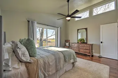 a bedroom with a bed and a ceiling fan at Picturesque Farmhouse on Working Almond Ranch in Oakdale