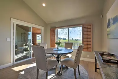 a dining room with a table and chairs and a window at Picturesque Farmhouse on Working Almond Ranch in Oakdale