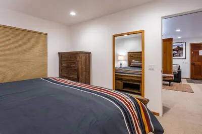 a bedroom with a bed and a mirror at Hidden Valley Village #103 nicely updated 1 bedroom 1 bathroom condo short 10 min walk from Village in Mammoth Lakes