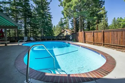 a swimming pool in a backyard with a wooden fence at Hidden Valley Village #103 nicely updated 1 bedroom 1 bathroom condo short 10 min walk from Village in Mammoth Lakes