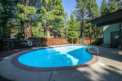 a swimming pool in a yard with a fence and trees at Hidden Valley Village #103 nicely updated 1 bedroom 1 bathroom condo short 10 min walk from Village in Mammoth Lakes