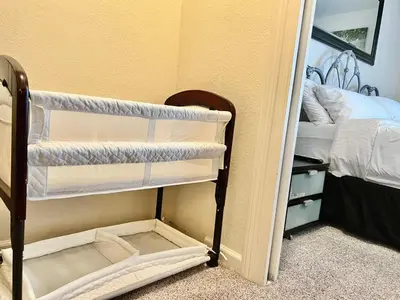 a small room with a bunk bed and a room with a mirror at DT Reno - 4BR Home with Patio, BBQ Grill, Games Room in Reno