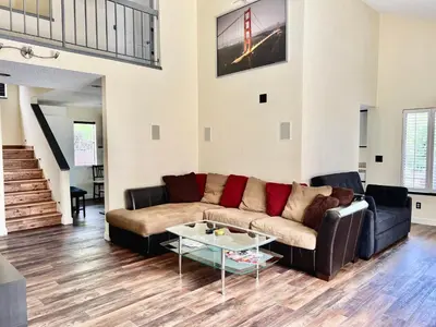 a living room with a couch and a table at DT Reno - 4BR Home with Patio, BBQ Grill, Games Room in Reno
