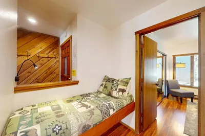 a bedroom with a bed and a desk and a chair at Snowcreek 27 in Mammoth Lakes