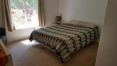 a bedroom with a bed in a room with a window at Explore Amador and Calaveras County. in West Point